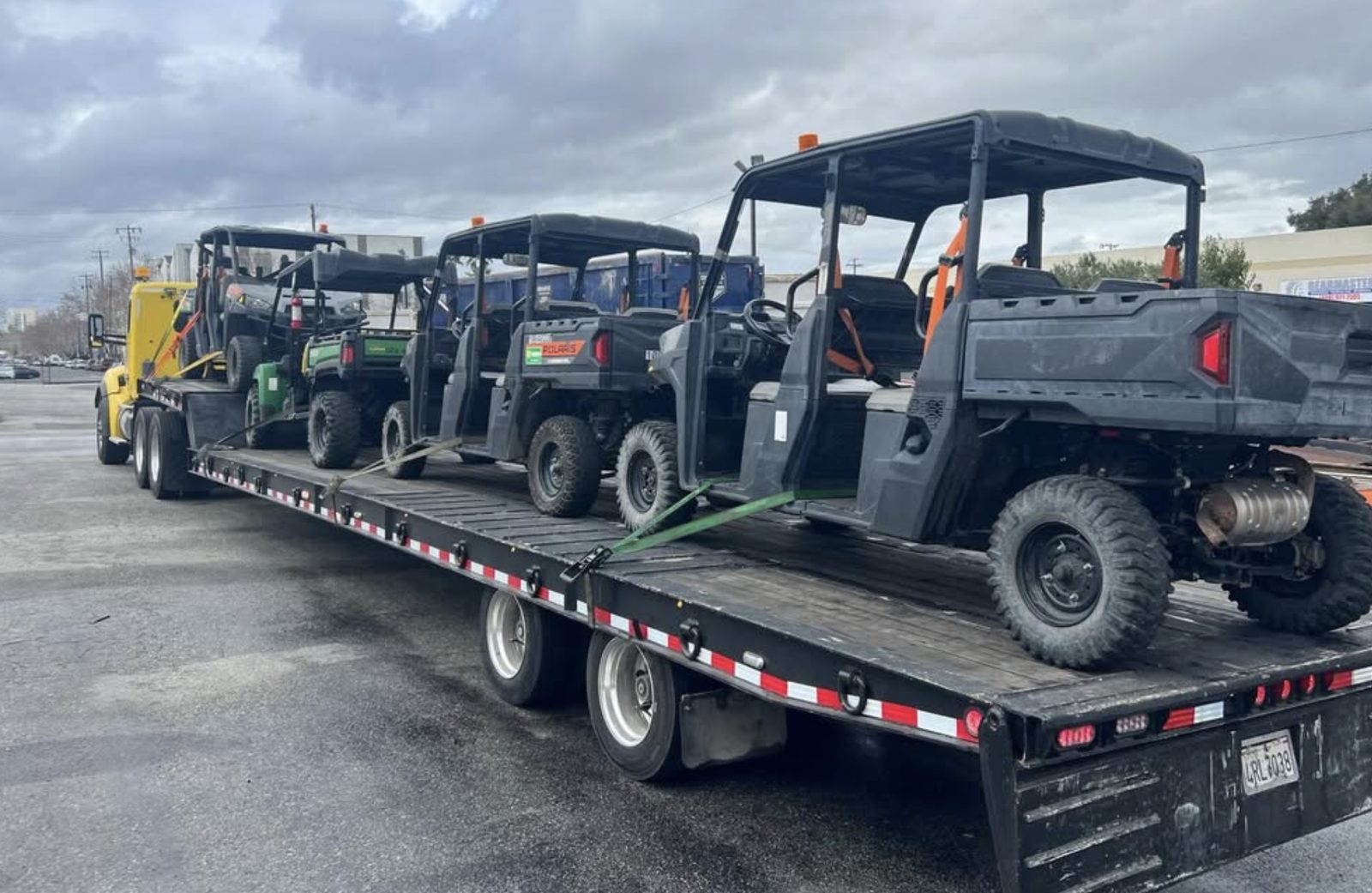 UTVs loaded on flatbed trailer